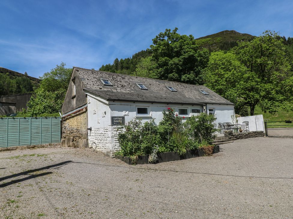 An outdoor view of a cottage with a parking sign at Daffodil Cottage in Blaencwm near Treorchy