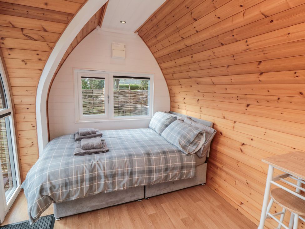A bedroom with a bed and window at Cosy Cocoon in Malton