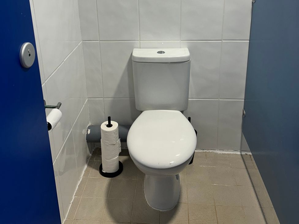 A bathroom with a toilet and toilet paper at Cosy Cocoon near Rillington