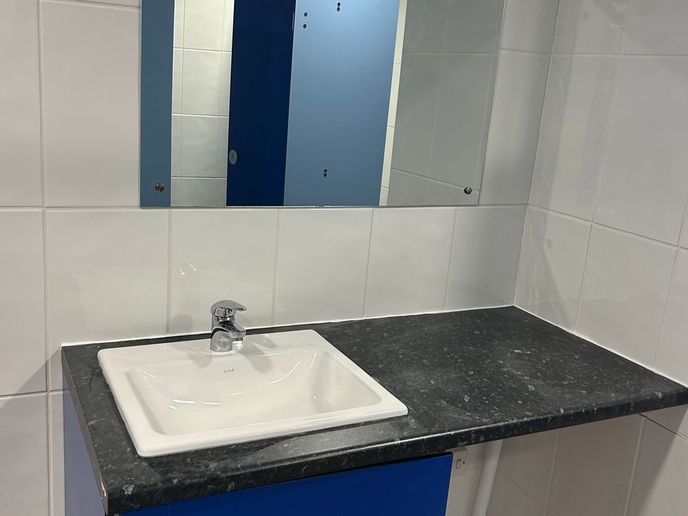 A bathroom with a sink and mirror at Cosy Cocoon near Rillington