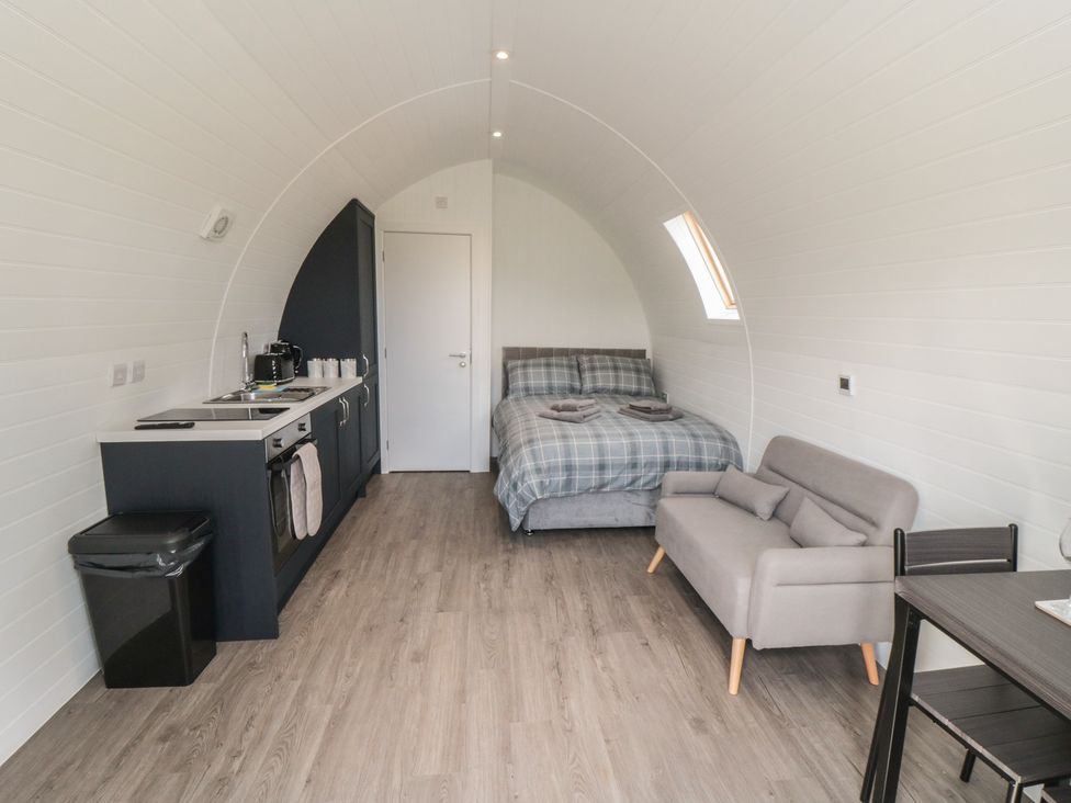 A studio with a kitchenette, bed, and seating area at Natures Nest in Malton