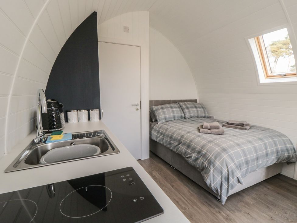 A hotel room with a bed and kitchenette at Natures Nest in Malton
