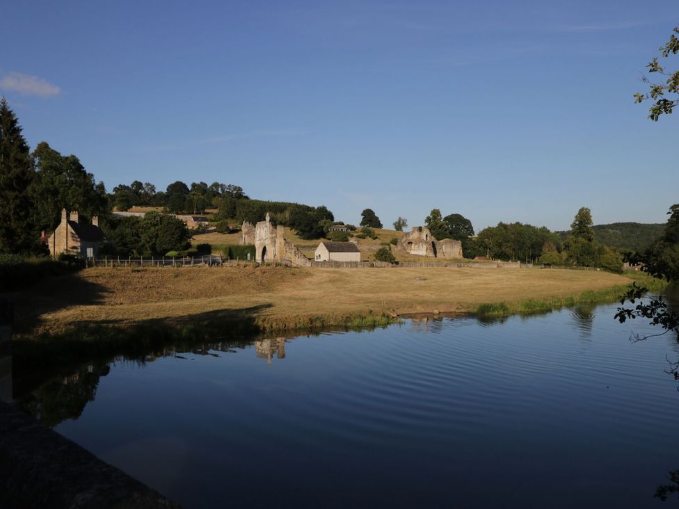 A view of buildings near a river at Natures Nest in Malton