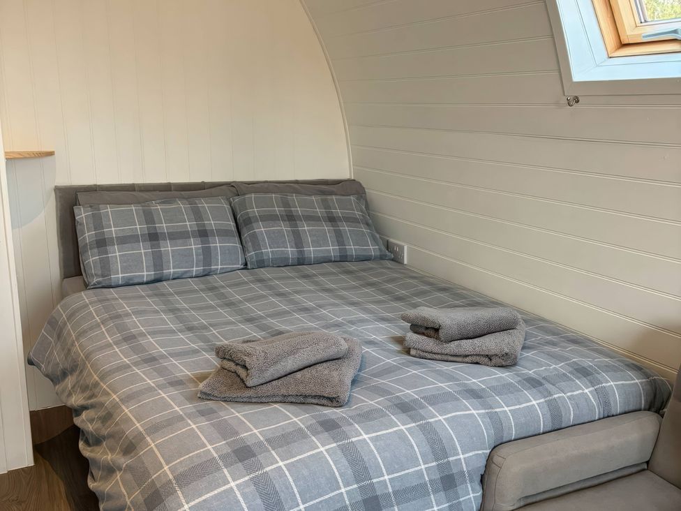 A bedroom with a bed and towels at Natures Nest near Rillington