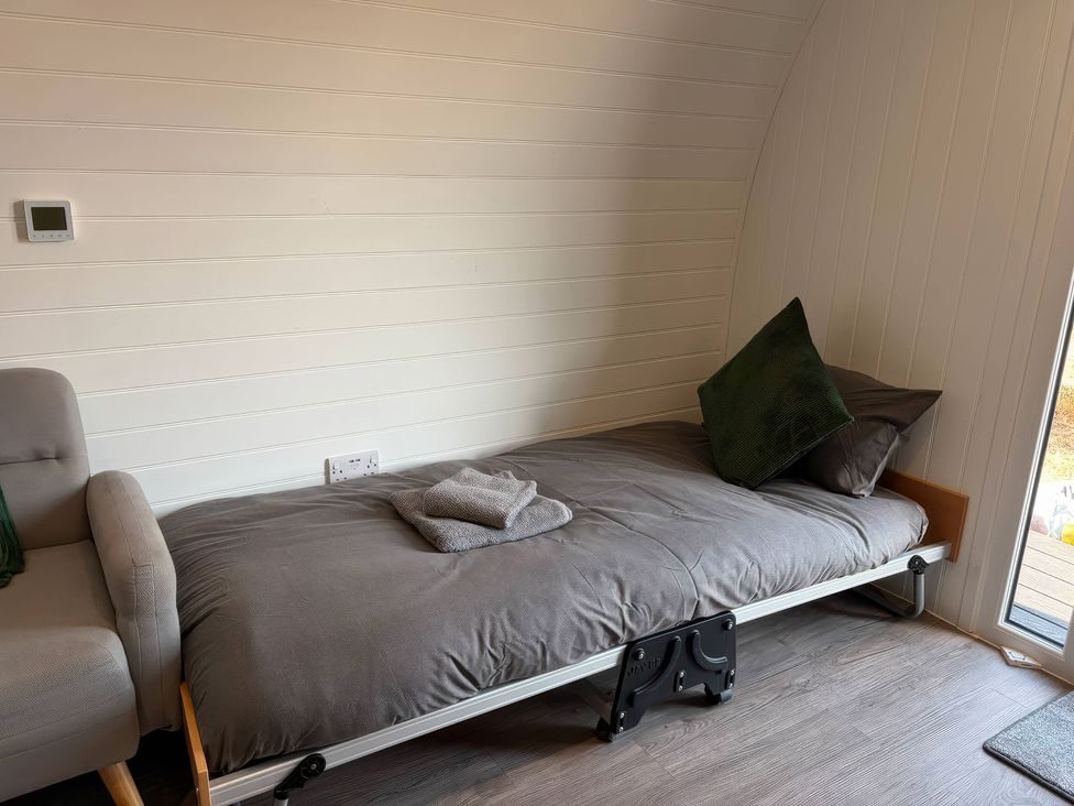 A bed with a pillow and towel in a bedroom at Natures Nest near Rillington