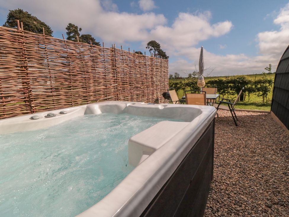 A hot tub with outdoor seating at Starlight Sanctuary in Malton
