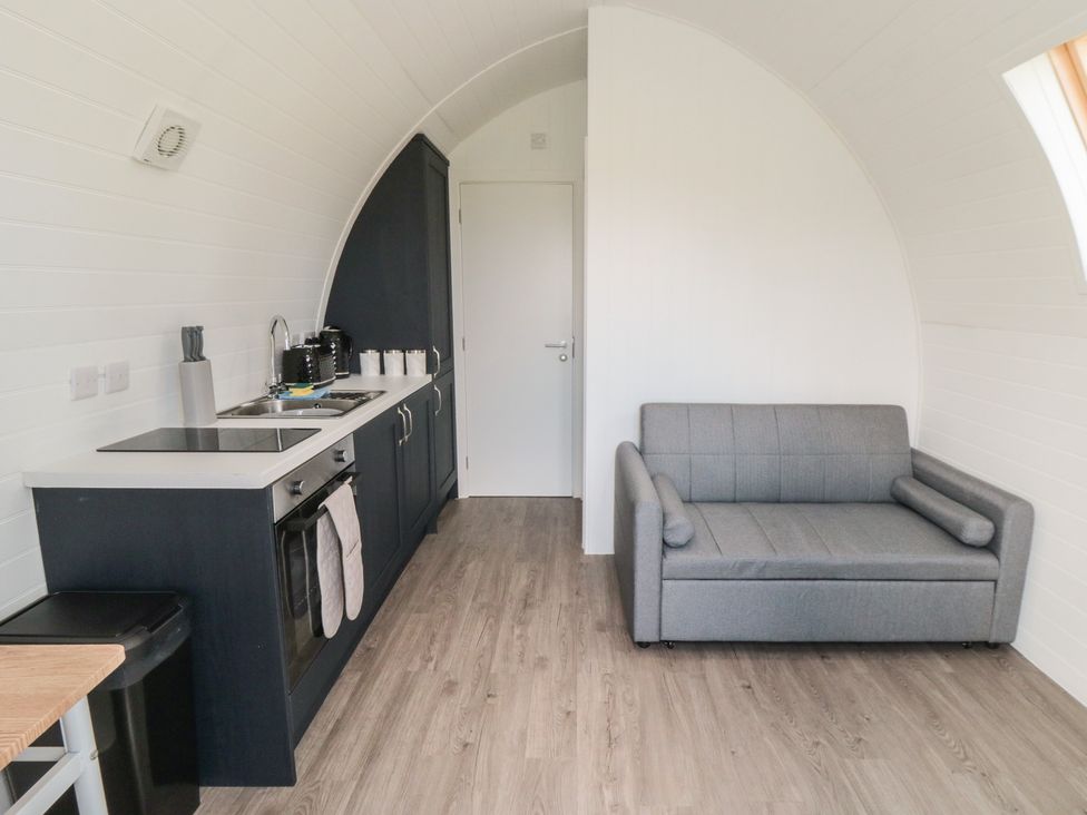 A kitchen with appliances and a sofa at Starlight Sanctuary in Malton