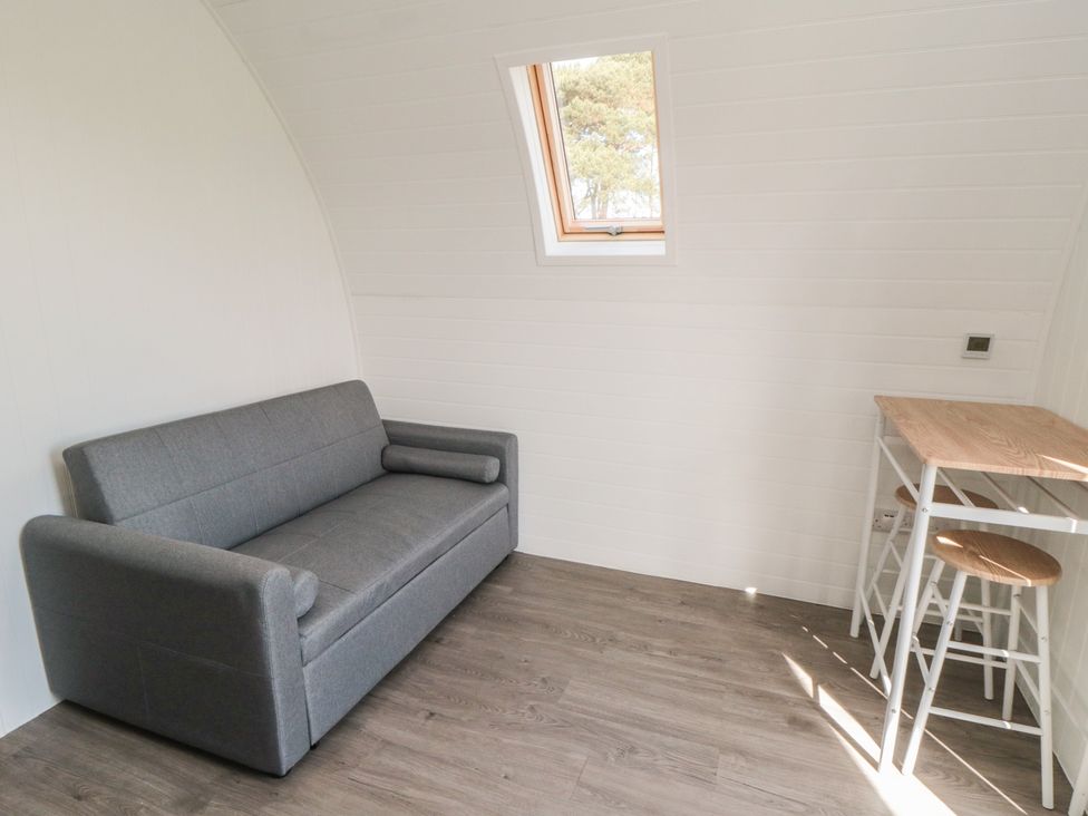 A living room with a sofa and a table at Starlight Sanctuary in Malton