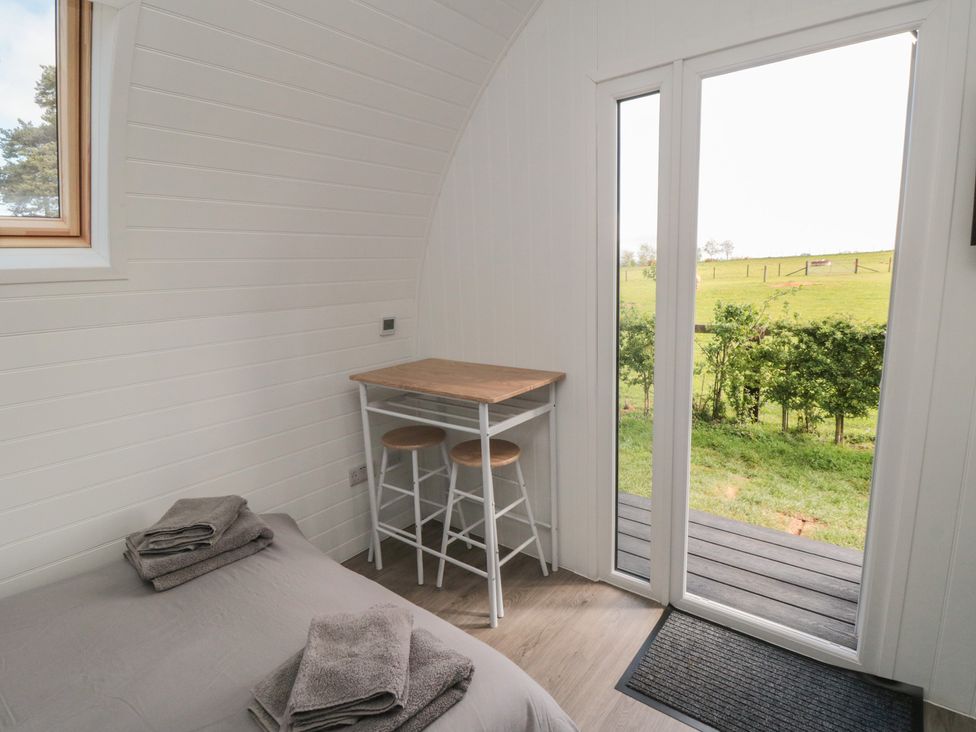 A bedroom with a bed and small table at Starlight Sanctuary in Malton