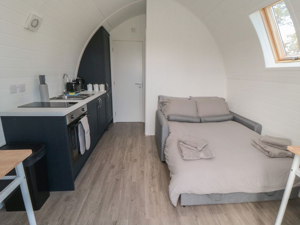 A kitchen and sleeping area with a sofa bed at Starlight Sanctuary in Malton