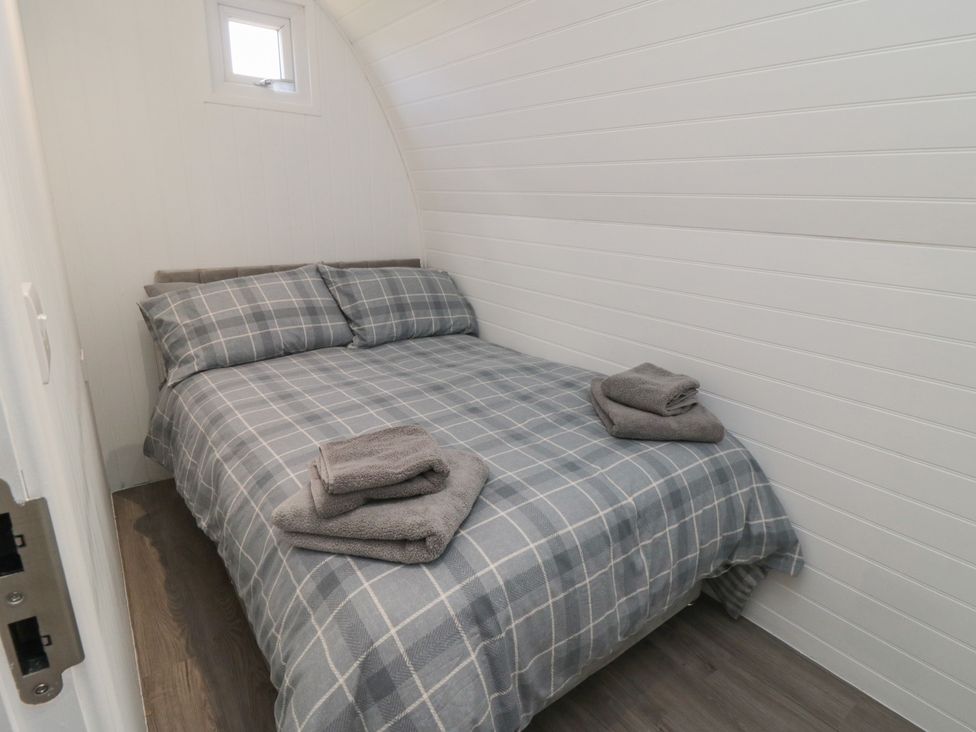 A bedroom with a bed and pillows at Starlight Sanctuary in Malton