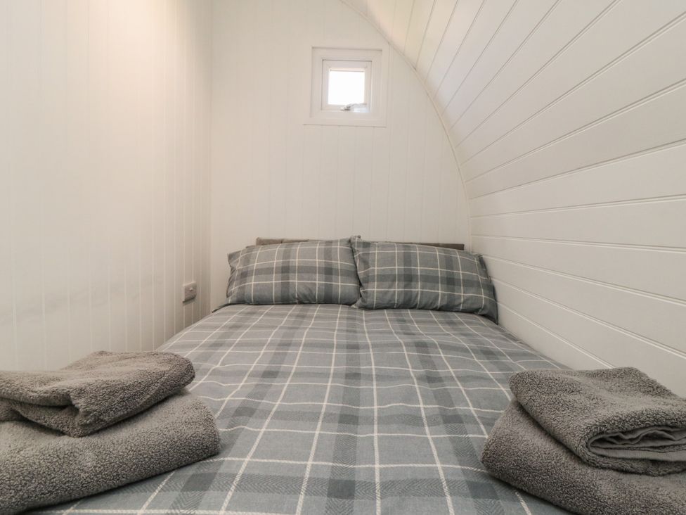 A bedroom with a bed and pillows at Starlight Sanctuary in Malton