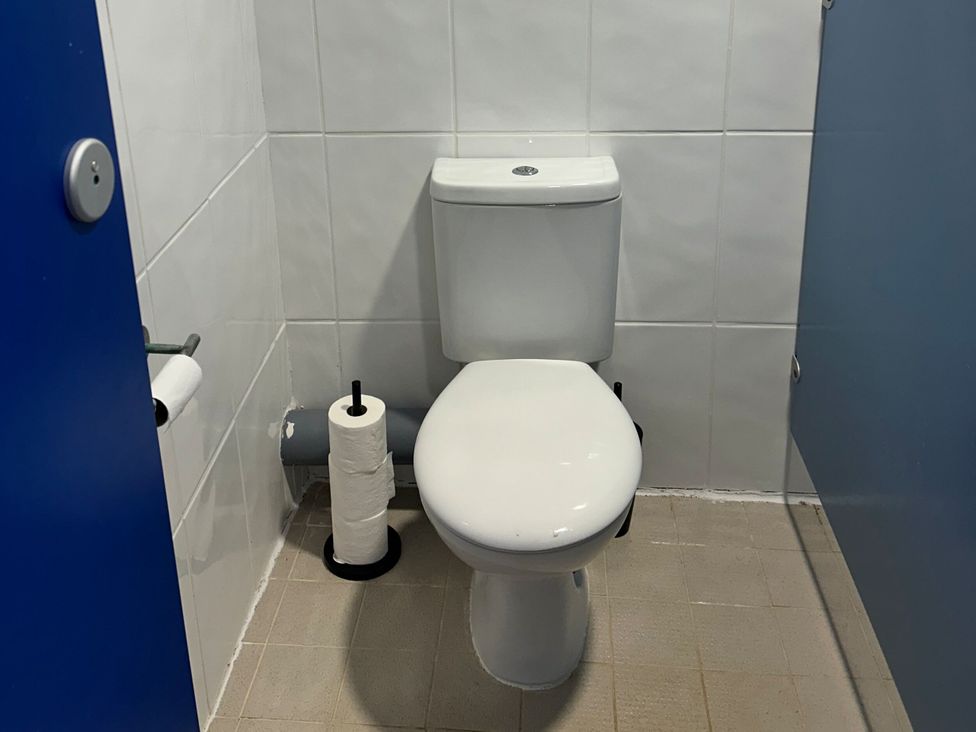 A bathroom with a toilet and toilet paper at Starlight Sanctuary near Rillington
