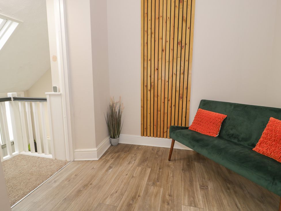 A hallway with a sofa and potted plant at Llety Cllyd in Barmouth
