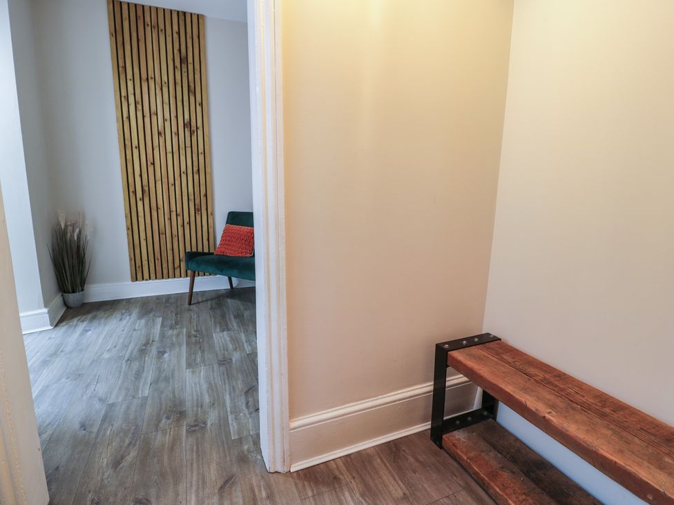 A hallway with a bench and plant at Llety Cllyd Barmouth