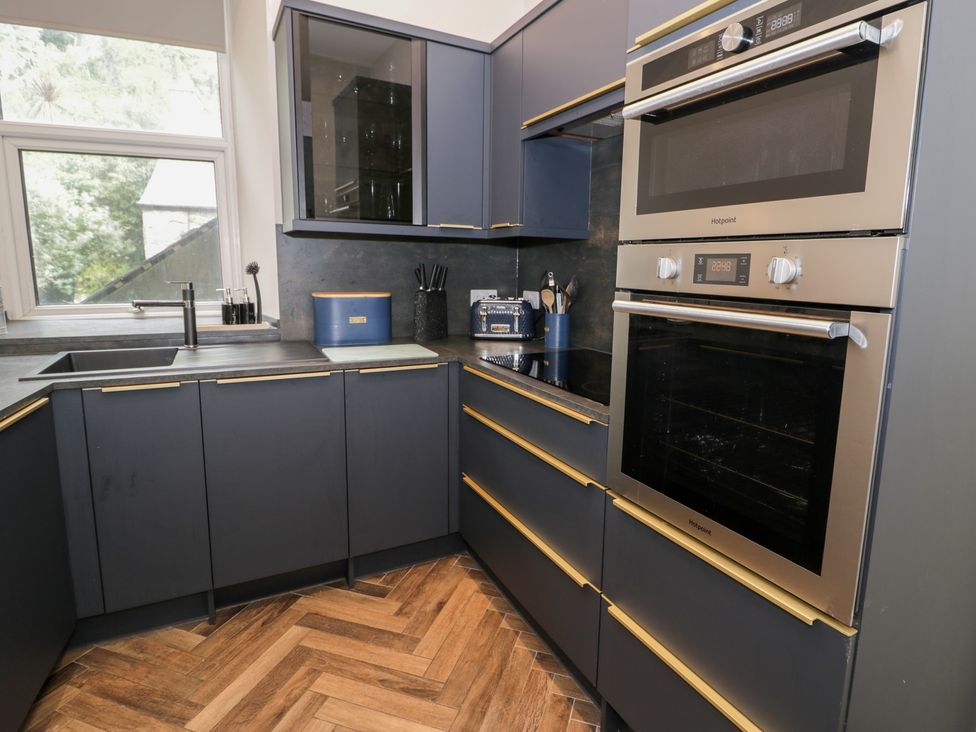 A kitchen with a sink and ovens at Llety Cllyd in Barmouth