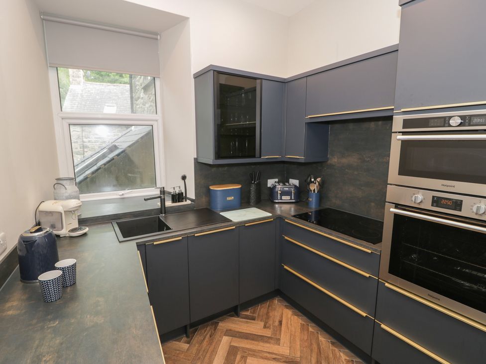 A kitchen with modern appliances and countertops at Llety Cllyd in Barmouth
