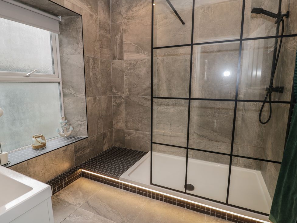 A bathroom with a shower and bathtub at Llety Cllyd in Barmouth