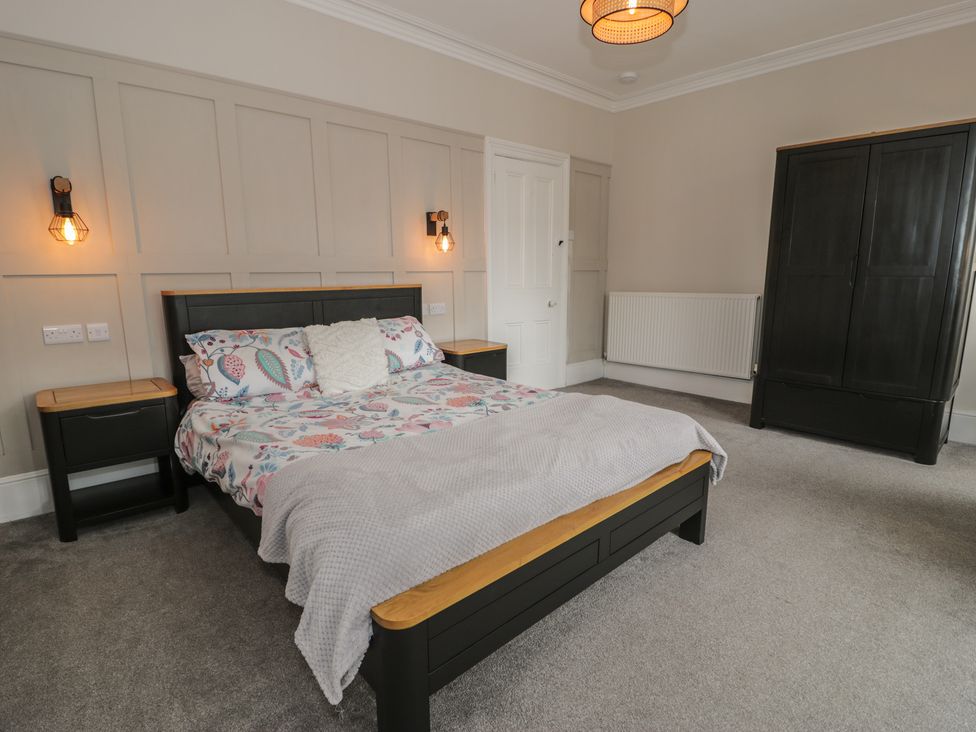 A bedroom with a bed and nightstands at Llety Cllyd in Barmouth
