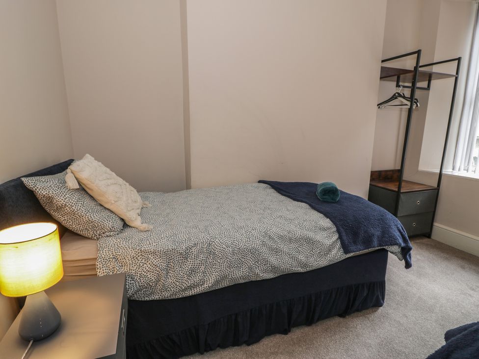 A bedroom with a bed and wardrobe at Llety Cllyd in Barmouth