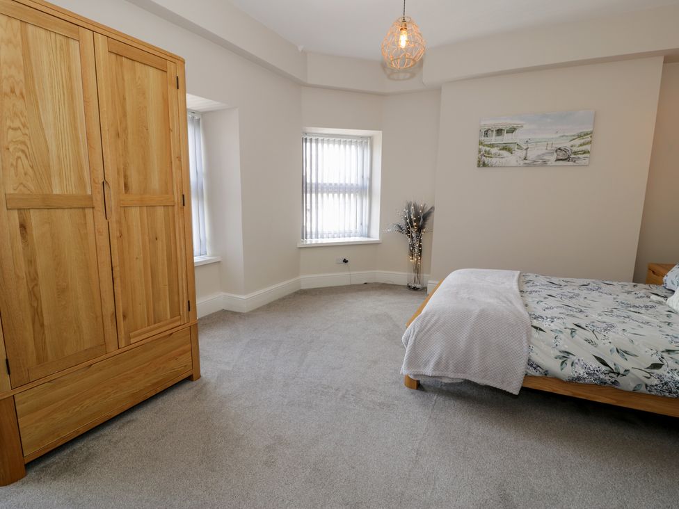 A bedroom with a wardrobe and bed at Llety Cllyd in Barmouth