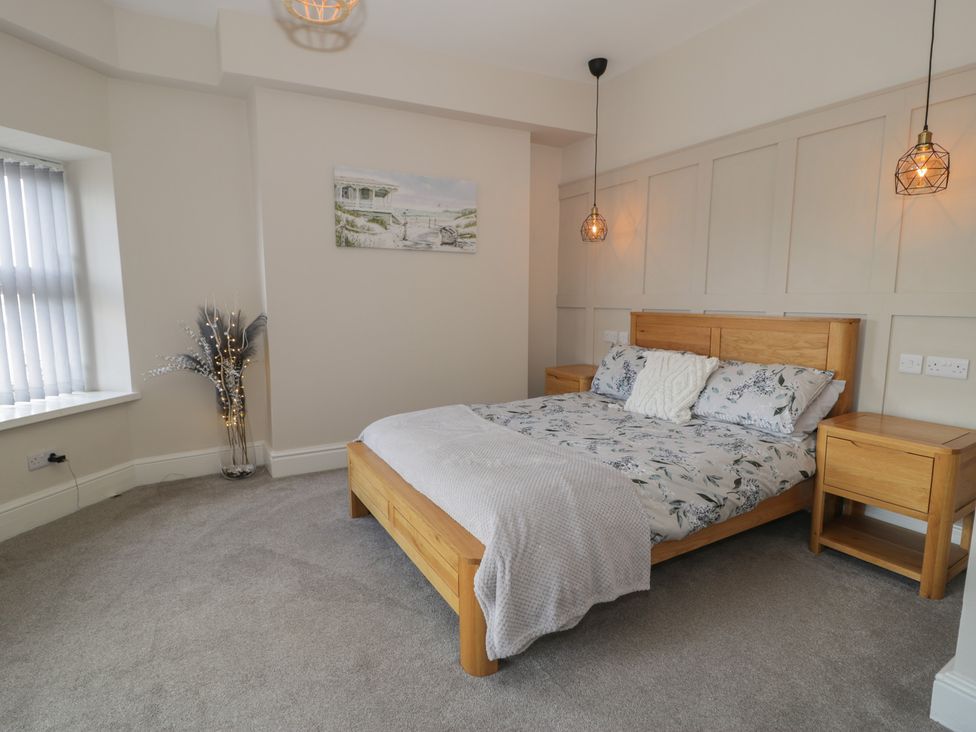A bedroom with a bed and two nightstands at Llety Cllyd in Barmouth