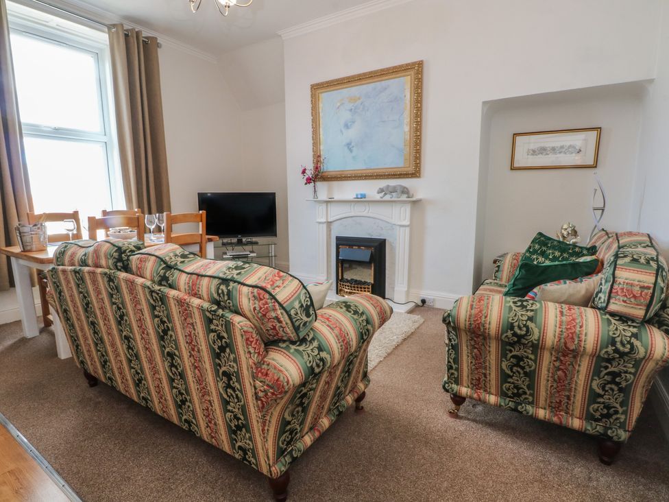 A living room with a sofa, table, and television at Apartment 3 in Lytham St. Annes