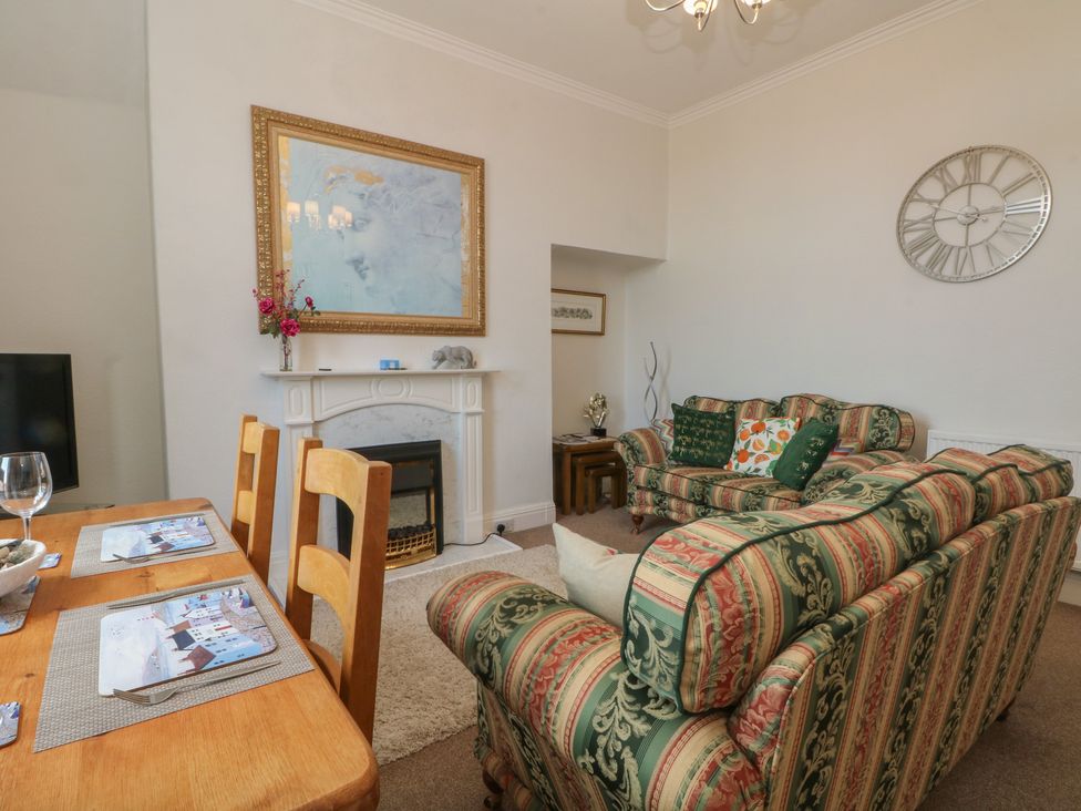 A living room with a dining table and sofa at Apartment 3 in Lytham St. Annes