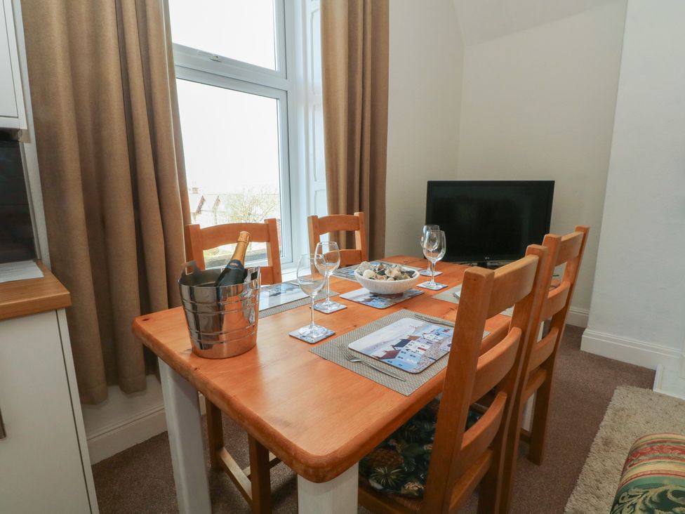 A dining room with a table set for four at Apartment 3 in Lytham St. Annes