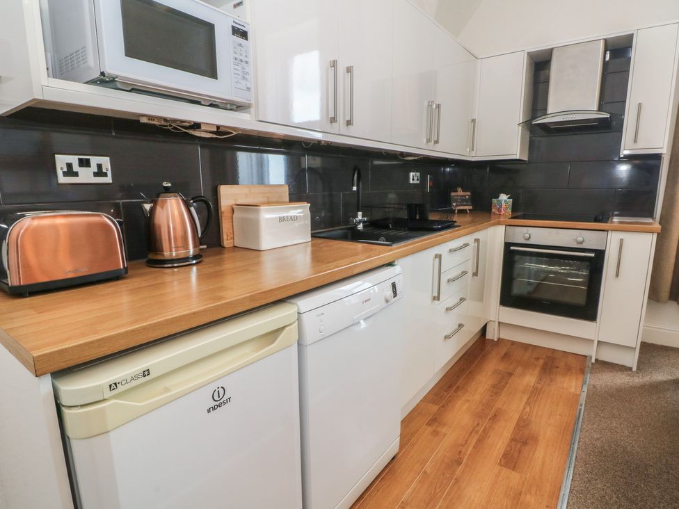A kitchen with appliances and cabinets at Apartment 3 in Lytham St. Annes