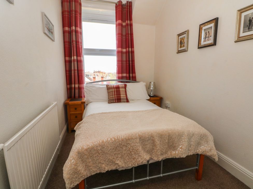 A bedroom with a bed and bedside table at Apartment 3 in Lytham St. Annes