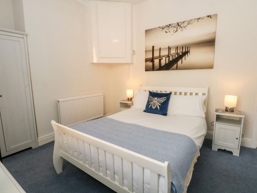 A bedroom with a bed and wardrobe at Apartment 3 in Lytham St. Annes