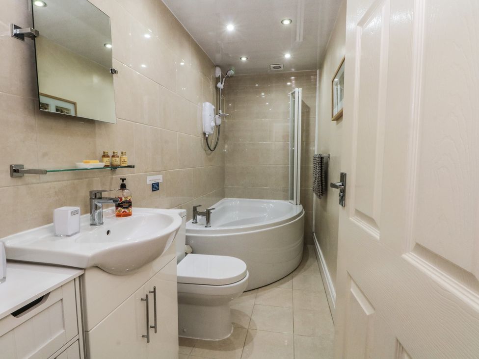 A bathroom with a bathtub, sink, and toilet at Apartment 3 in Lytham St. Annes