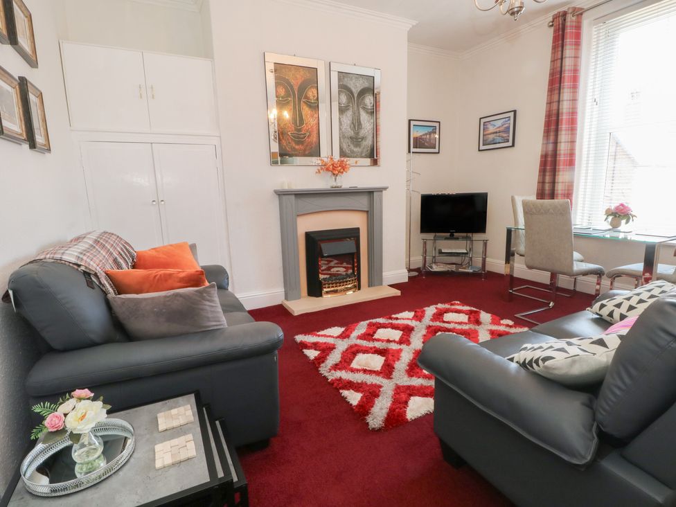 A living room with a sofa and television at Apartment 4 in Lytham St. Annes
