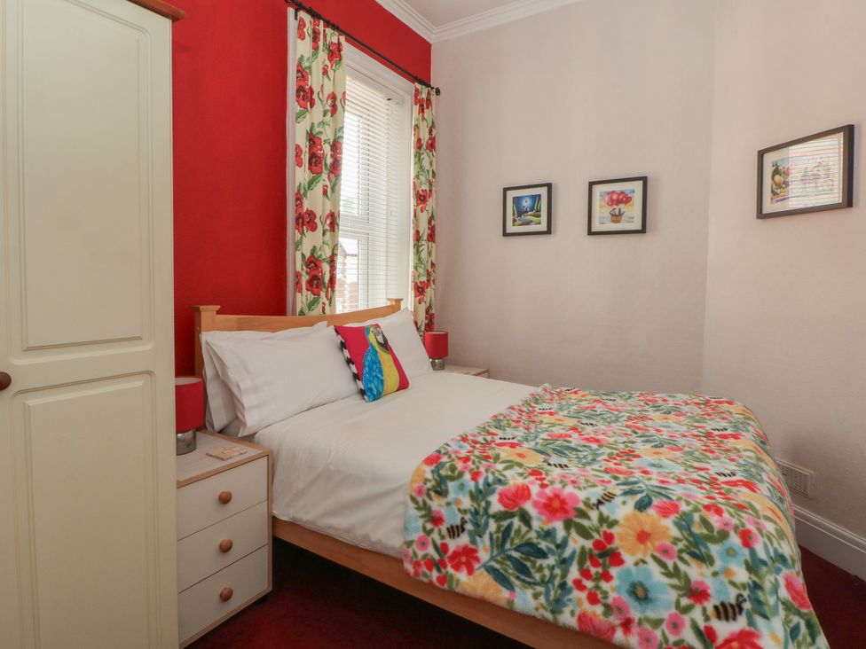 A bedroom with a bed and wardrobe at Apartment 4 in Lytham St. Annes
