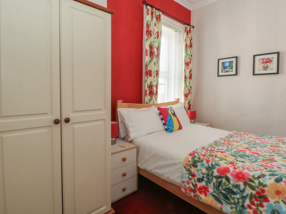 A bedroom with a bed and a wardrobe at Apartment 4 in Lytham St. Annes