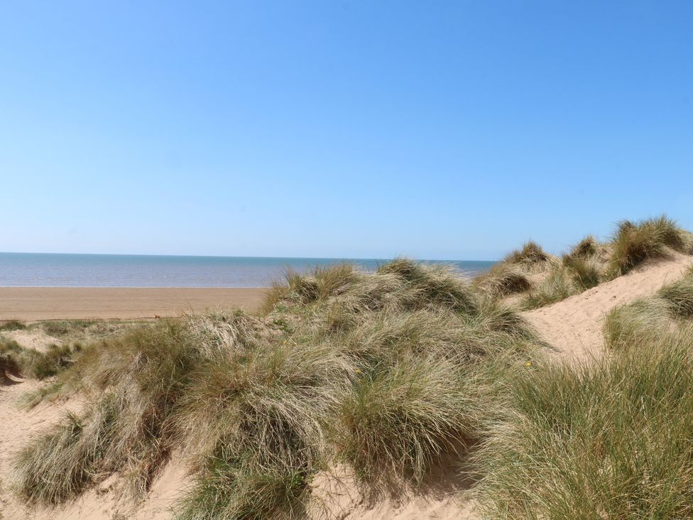 A view of sand dunes with grass and ocean at Apartment 4 in Lytham St. Annes