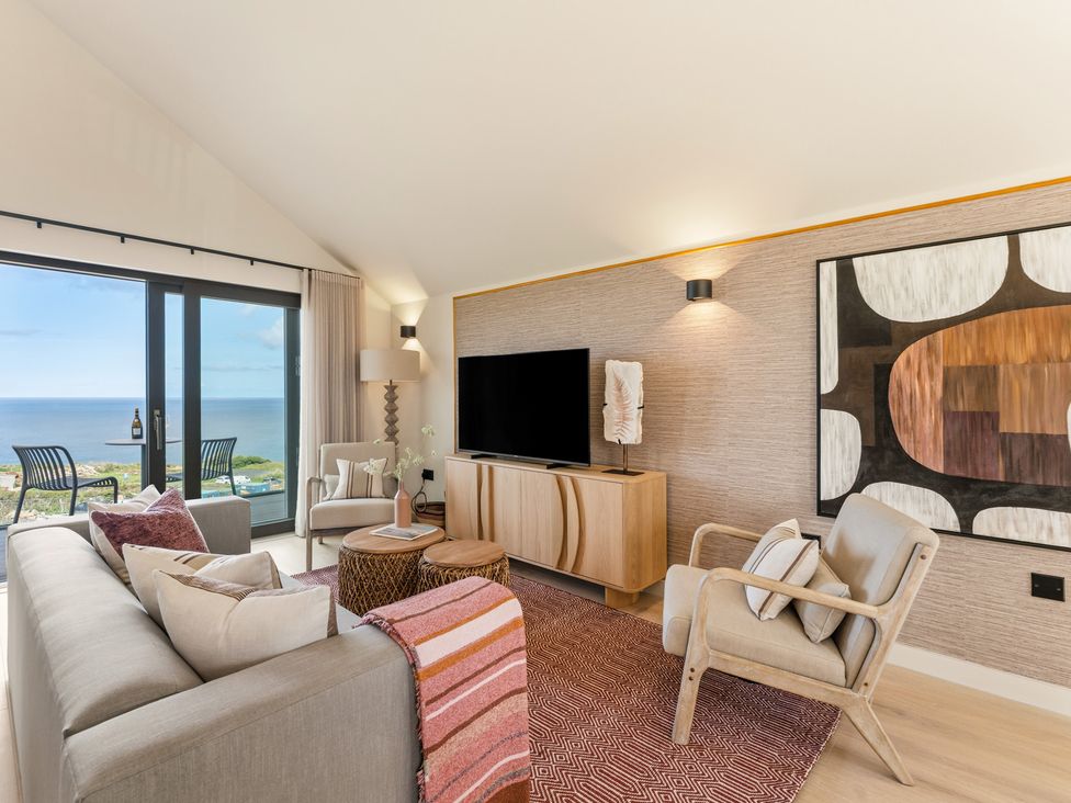 A living room with a television and sofa at Clifftop House Hot Tub in St Ives