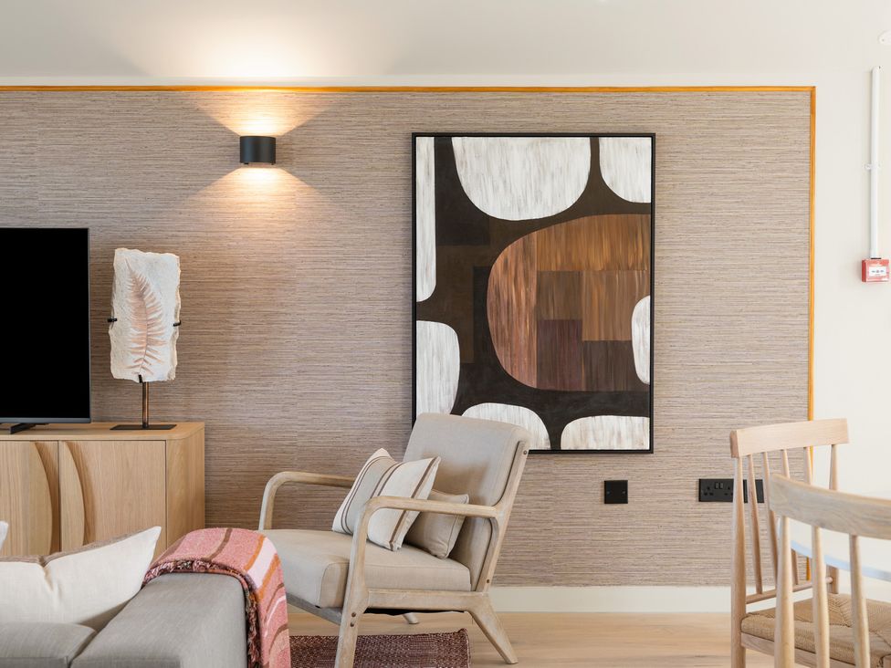 A living room with a television and artwork at Clifftop House Hot Tub in St Ives