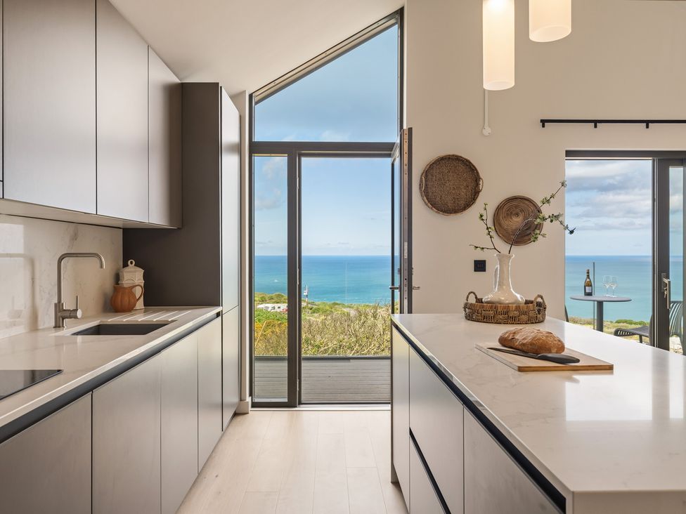 A kitchen with ocean view at Clifftop House Hot Tub in St Ives