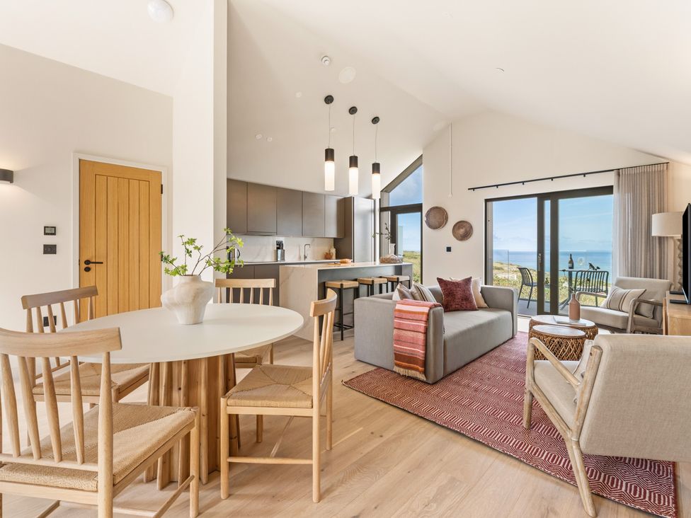 A living room with a round table and chairs at Clifftop House Hot Tub St Ives