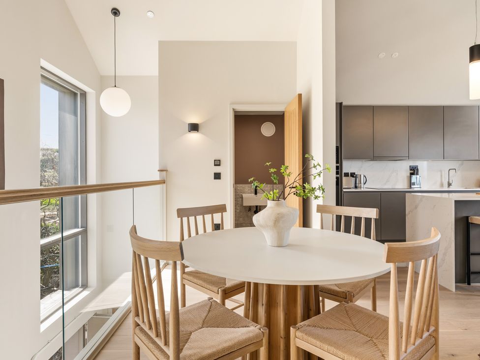 A dining area with a table and chairs at Clifftop House Hot Tub in St Ives
