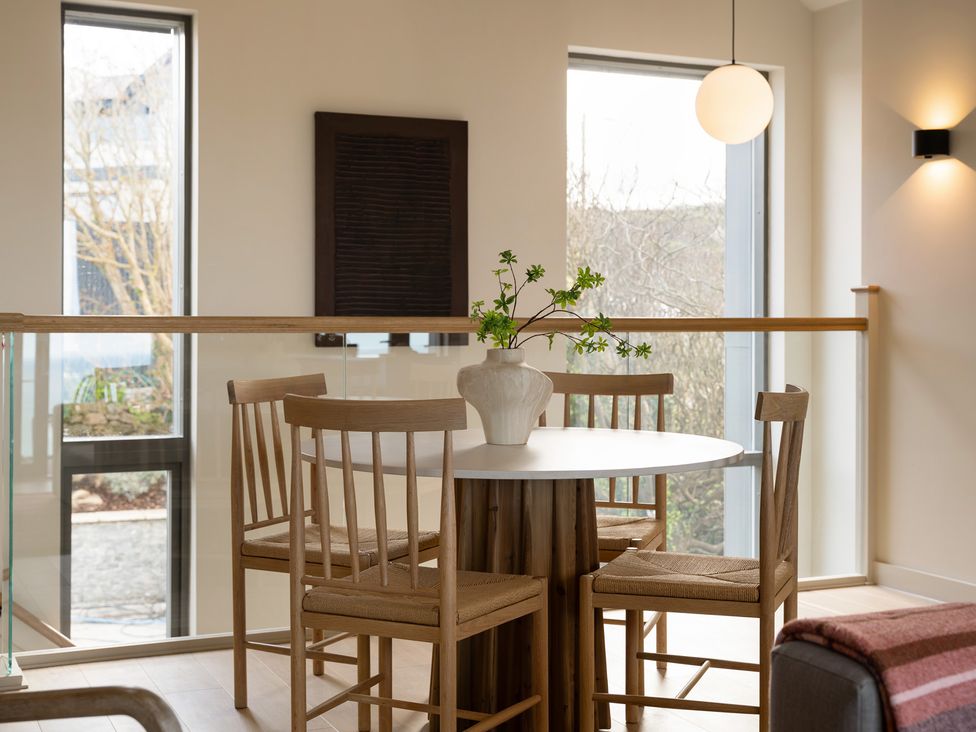 A dining room with a table and chairs at Clifftop House Hot Tub St Ives