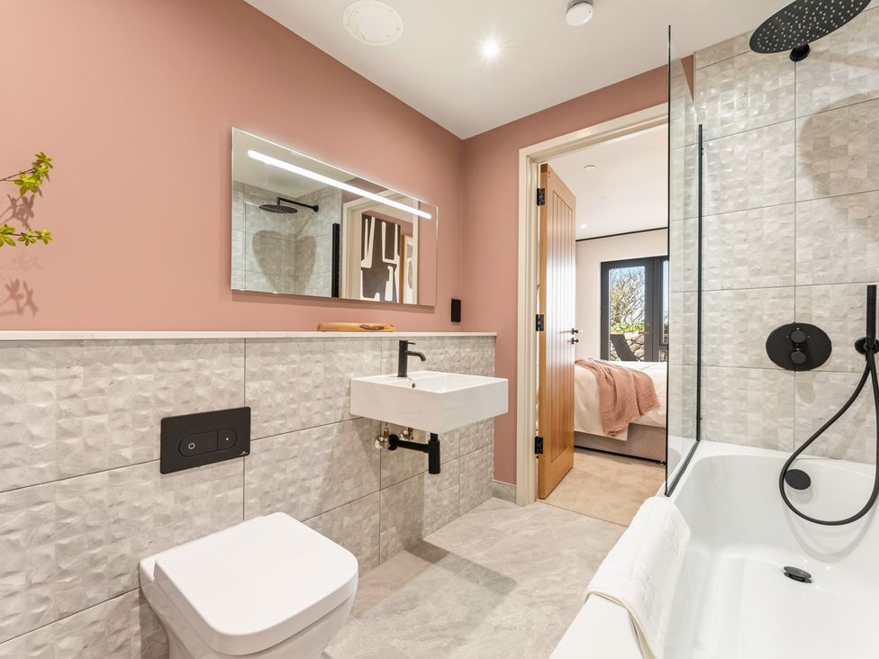 A bathroom with a sink and a bathtub at Clifftop House Hot Tub in St Ives