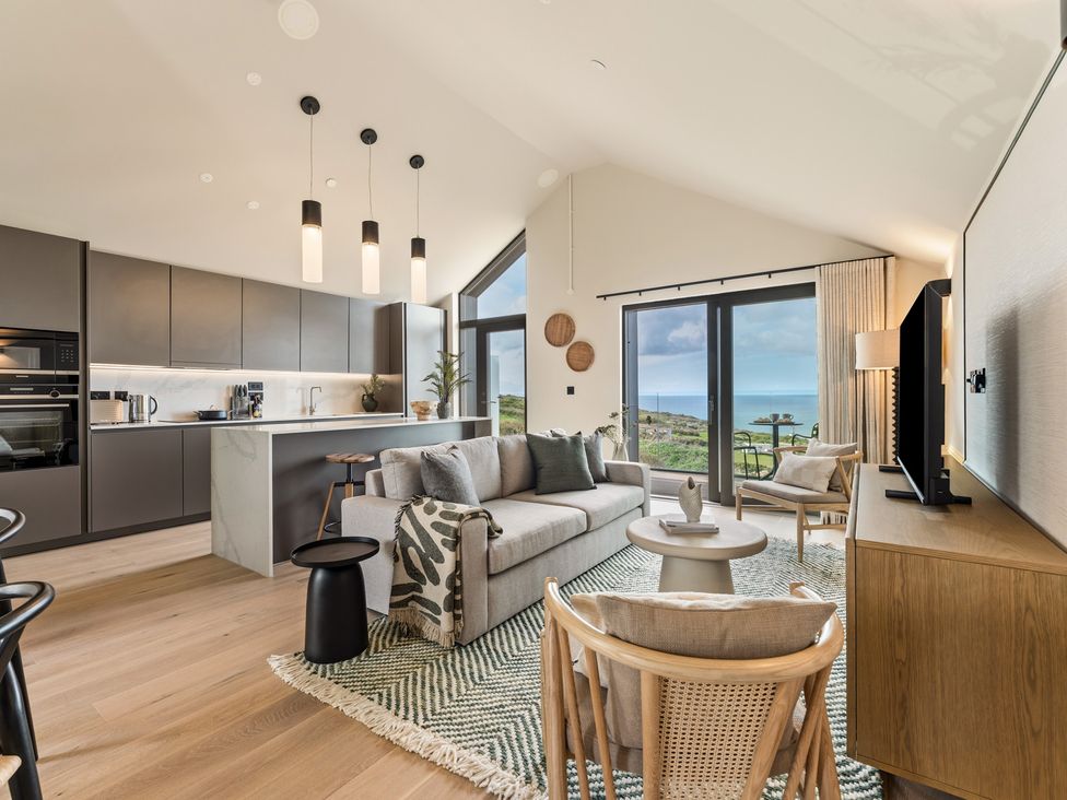 A living room with kitchen and ocean view at tbc in St. Ives