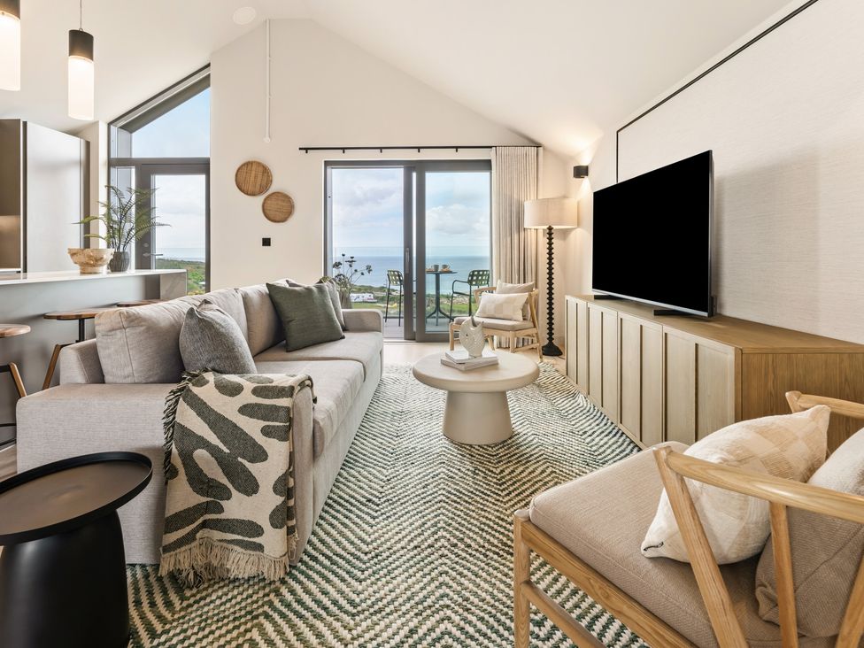 A living room with a sofa and table at tbc in St. Ives