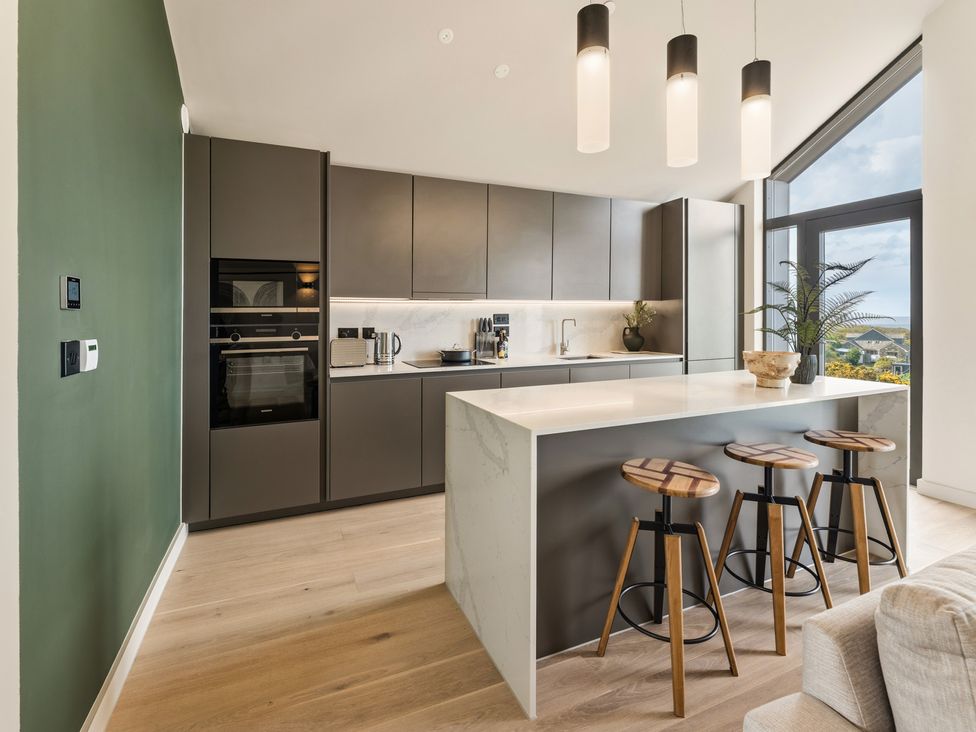 A kitchen with cabinets and a countertop at tbc in St. Ives