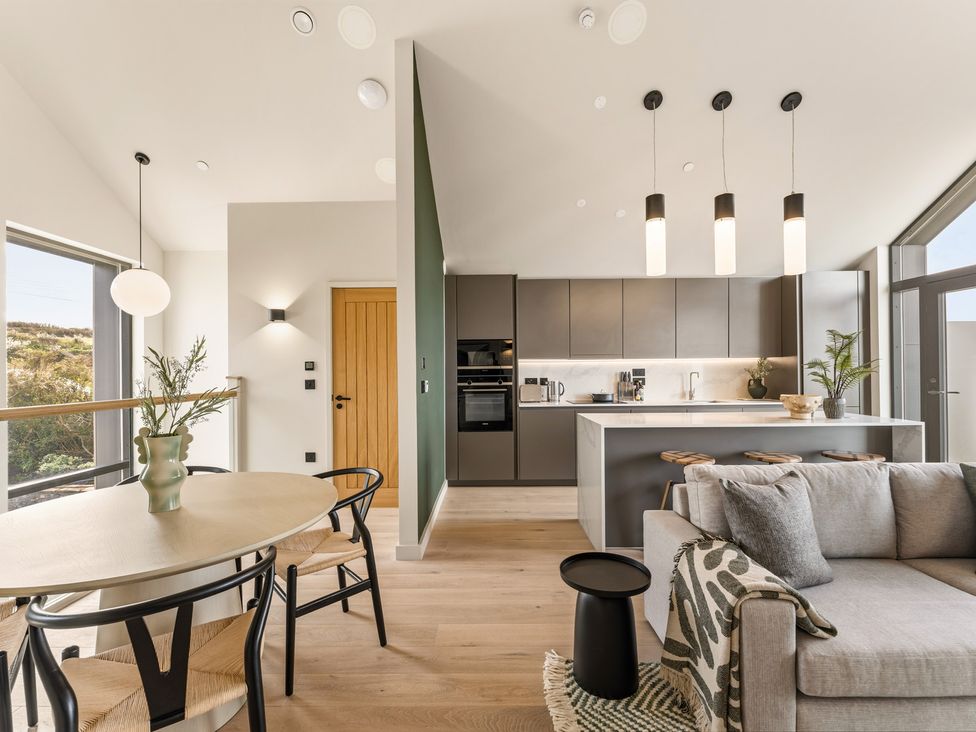 A kitchen with a dining table and sofa at tbc in St. Ives