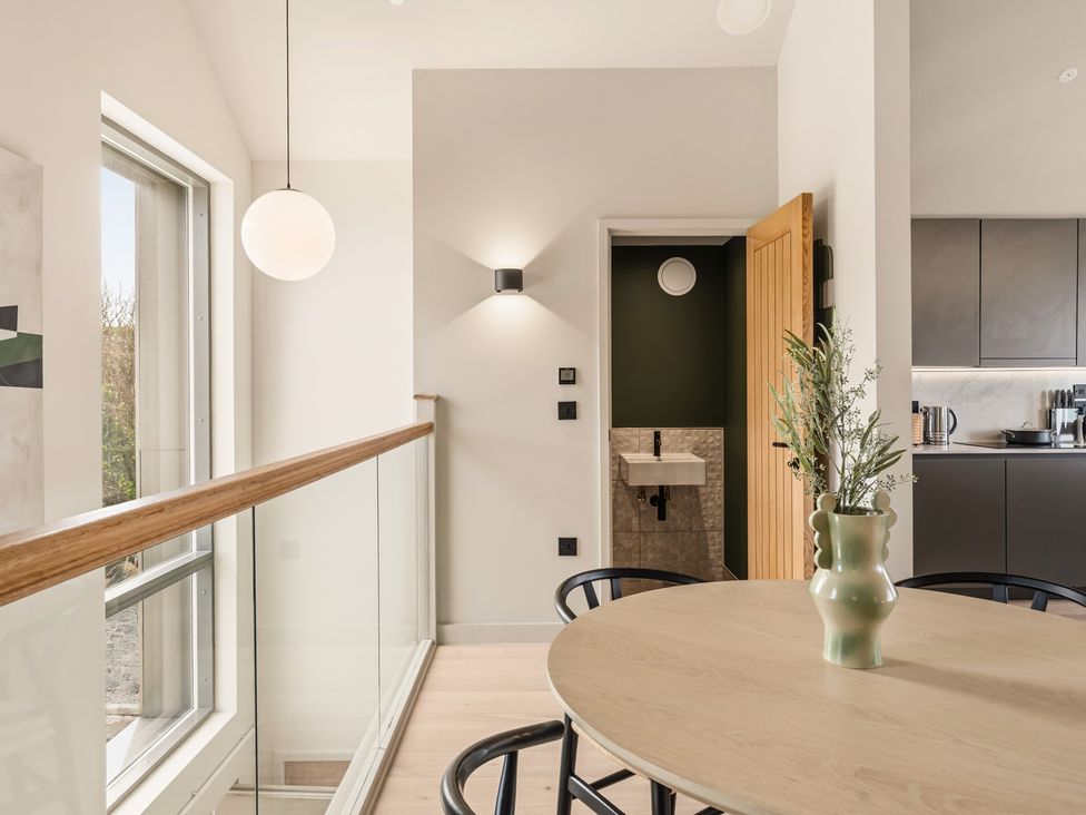 A kitchen with a table and chairs at tbc in St. Ives