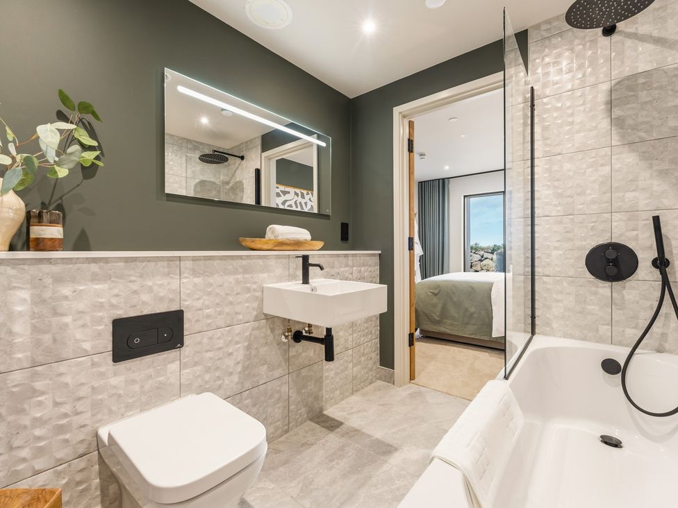 A bathroom with a sink, toilet, and shower at tbc in St. Ives